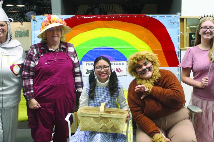 DEBBIE EINERSON (from left), Tammy Murphy, Dorthy Kaylie Como, Aspyn Kelley and Nikayla Glidden dress up in the Wizard of Oz theme and greet everyone as they come into the Excelsior Springs Community Center.