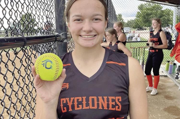 JOSIE CASLER displays a home run ball hit for the Cyclones during the Heartland World Series. DUSTIN DANNER | Staff