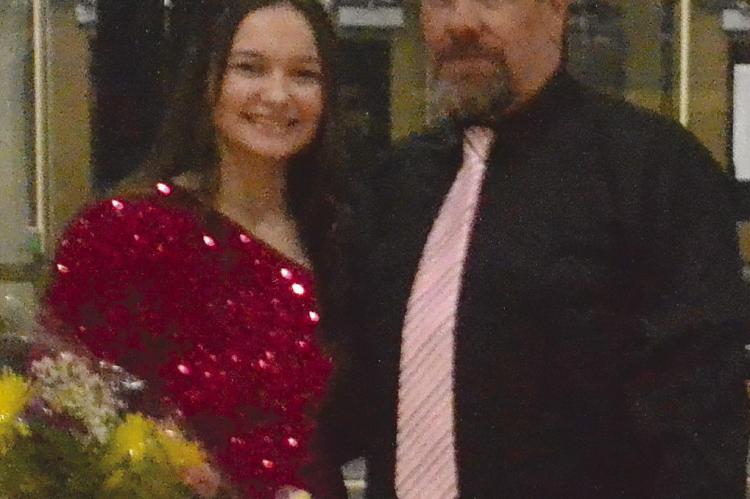 CROWNED SOPHOMORE princess Josie Casler (left) stands with her father, Corey Casler.