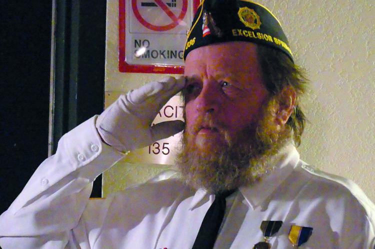 AMERICAN LEGION POST 256 member Kent Cates, salutes in remembrance at the Post Everlasting Ceremony.
