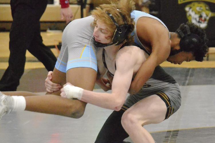 EXCELSIOR SPRINGS SOPHOMORE Cooper Collins lifts Grandview’s Josiah McNeal and prepares for a turn and takedown during the Tigers’ Jan. 17 Greater Kansas City Suburban Conference-Blue Division home dual. DUSTIN DANNER | Staff