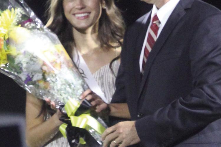 EXCELSIOR SPRINGS High School Junior Ava Morton (left) accepts her crown with Chad Morton.