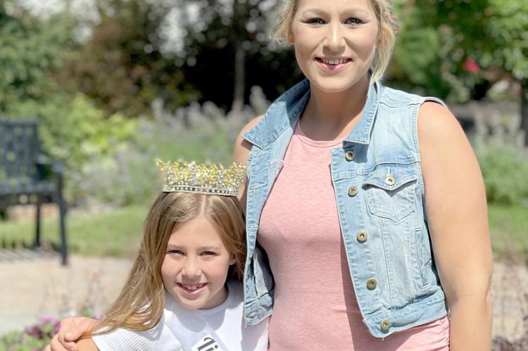 LITTLE MISS Waterfest Norah Craven, along with pageant coordinator and sponsor Kalyn Goode, celebrate Norah’s three years as queen with a new tiara.