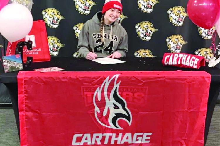 EXCELSIOR SPRINGS senior Alyssa Betts signs her letter of intent to study and compete in women’s wrestling at Carthage College. DUSTIN DANNER | Staff
