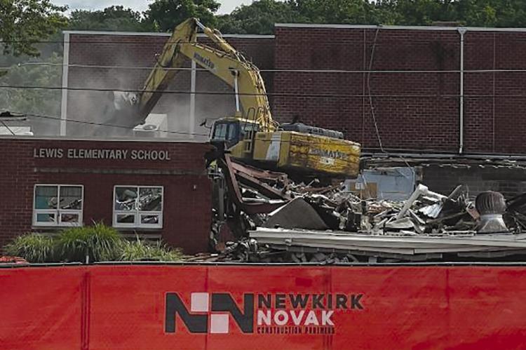 An excavator begins demolishing Lewis Elementary School. ELIZABETH BARNT | Staff