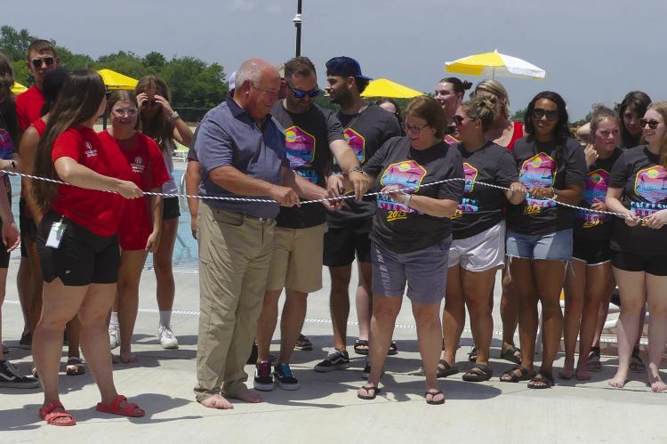 City officials were joined by staff members of the community center, school board and Royal Construction to cut the pool rope, marking the grand opening of the outdoor pool. ELIZABETH BARNT | Staff