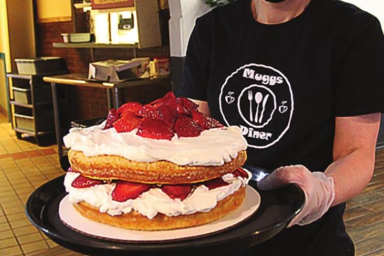 STRAWBERRY SHORTCAKE is a dessert in demand at Muggs Diner, 119 Crown Hill Road, Excelsior Springs, owner Jill Willams says. She shows off the freshly made treat.
