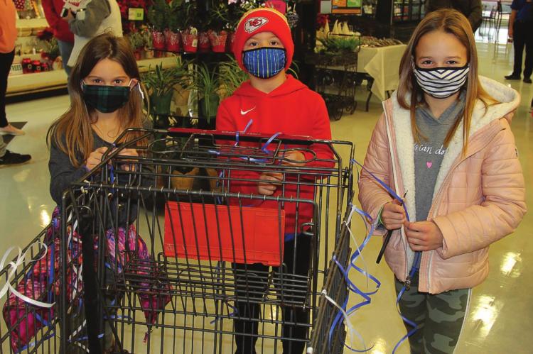 HIS BIGGEST FANS: Kenny Manley’s children – Taryn, 8; Ryker, 7; and Kara, 10 – are ready for him to start the shopping spree at the Excelsior Springs Price Chopper.
