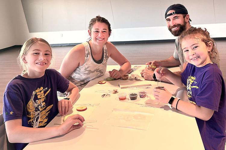 Above: HAILEE ARNOLD leads a yoga class on Sept. 24 for the Excelsior Springs Community Center’s Family Health and Fitness Day. Six families attend and engage in activities such as yoga, giveaways and a healthy snack lesson. Right: THE FRICK FAMILY: Aubrey, Meghan, J.D. and Emmy Frick enjoy their “healthy donuts” at the Family Health and Fitness Day.