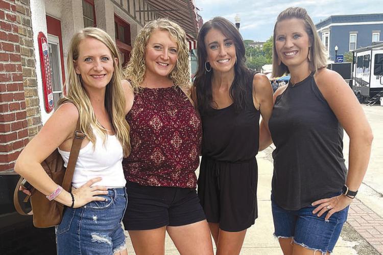 VISITORS JORDAN COLE, Abbie Jansma, Tasha Hulstein and Kaitlin Tade enjoy the live music, entertainment and fireworks in downtown Excelsior during this year’s BBQ Fly-In on the River.