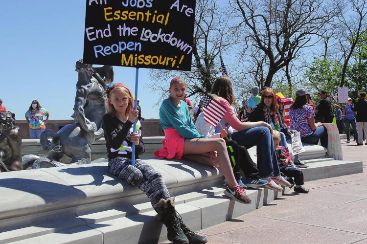 THE CROWD at the Capitol on Tuesday includes Clara Carter, 9, who attends with one older and two younger siblings, and her mother, who supports the Reopen Missouri message.