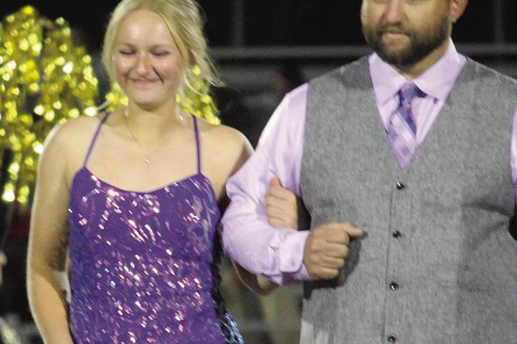 EXCELSIOR SPRINGS High School Senior Homecoming Queen Chloe Carlyle (left) walks with her escort, Clay Carlyle prior to being crowned. More photos on page 6, 7 and 8. MIRANDA JAMISON | Staff