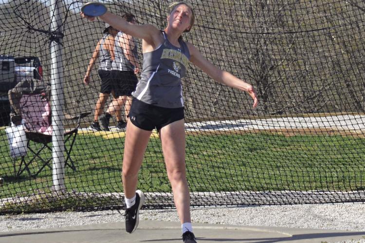 KINLEY ROGERS, a first-year high schooler, attempts a discus throw during the Highway 92 Meet April 13 at Tiger Stadium. DUSTIN DANNER | Staff