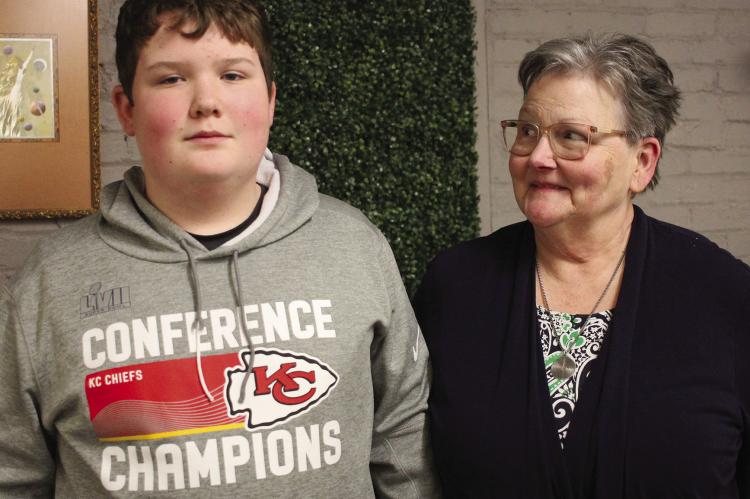 CASH ADAMS, 13, and his grandmother Mary Adams (right) appreciate the community’s support with his injury after the Chiefs rally. SOPHIA BALES | Staff