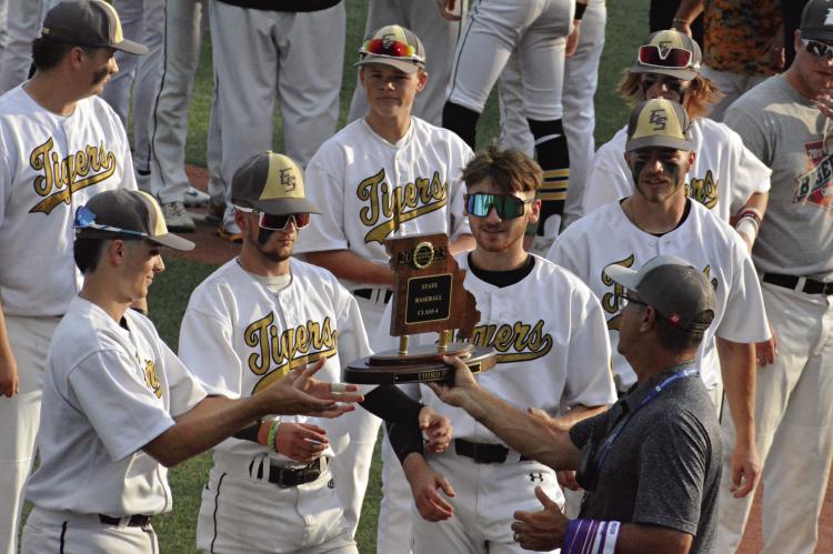 MEMBERS OF THE Excelsior Springs baseball team receive the Class 4 third-place trophy June 1 at Sky Bacon Stadium. Tigers pictured are (front row, from left) Mason Danner, Colson Moore, Brendan Blackburn, Broc Dusek; (back row) Brayden Lewis, Klayton Glaspy, Cooper Collins and Simon Holst, assistant coach. Additional baseball coverage on pages 6-7. SHAWN RONEY | Staff