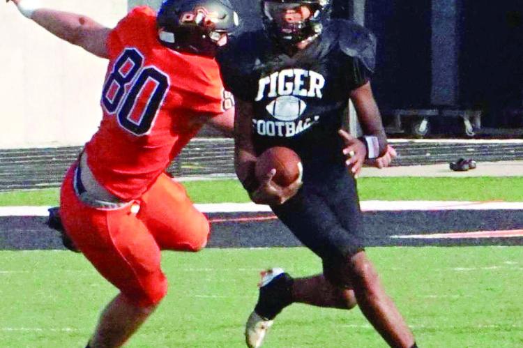 SOPHOMORE MARQUEZ McCANT, shown attempting to avoid a would-be Platte County tackler during an Aug. 18 preseason jamboree hosted by Platte County, has received the keys to drive the Excelsior Springs offense. DUSTIN DANNER | Staff