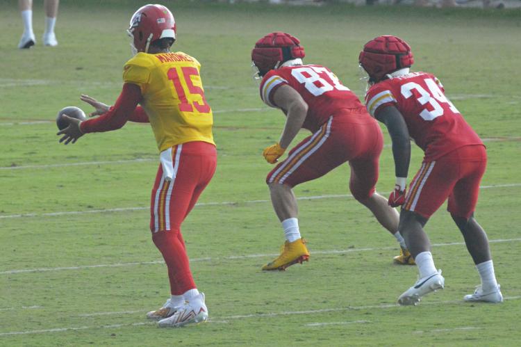 A GREAT TELEPHOTO lens can come in handy at some sports events, as this recent photo of the Kansas City Chiefs in training camp at St. Joseph shows. Pictured are Patrick Mahomes II (No. 15), Travis Kelce (No. 87) and Deneric Prince. SHAWN RONEY | Staff