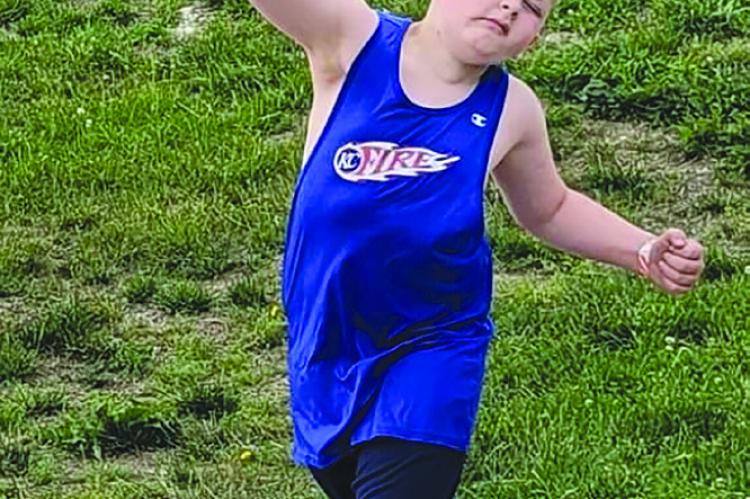 DURING COMPETITION, Cian Miller throws a shot-put with all his might.