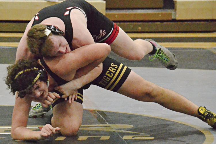JUNIOR ANTHONY CIRCO (bottom position) works to get free from Marshall’s Tyler Brooks during Jan. 25 dual action at Excelsior Springs. DUSTIN DANNER | Staff