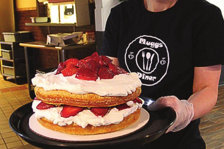 STRAWBERRY SHORTCAKE is a dessert in demand at Muggs Diner, 119 Crown Hill Road, Excelsior Springs, owner Jill Williams says. She shows off the freshly made treat while showing concern that the virus hurts business. J.C. VENTIMIGLIA | Staff