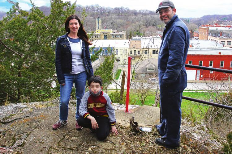 THE RADECKI family closes on the old Hotel Castle Rock property in downtown Excelsior Springs. From left are Krissy, Riley and Ryan Radecki, who reveal that their business plan for “the hill” includes creating an apiary by summer, with a possible conservatory and food stand for the future. J.C. VENTIMIGLIA | Staff