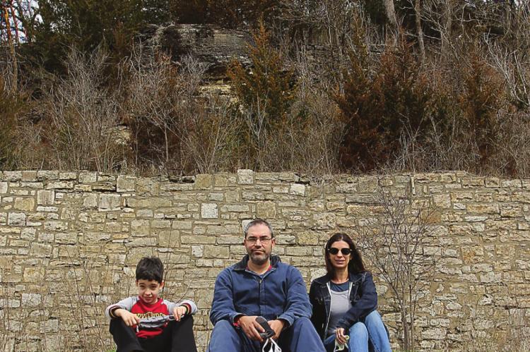 SITTING in front of the retaining wall, the new owners of the former Hotel Castle Rock property are, from left, Riley, 10; and his parents, Ryan and Krissy Radecki.