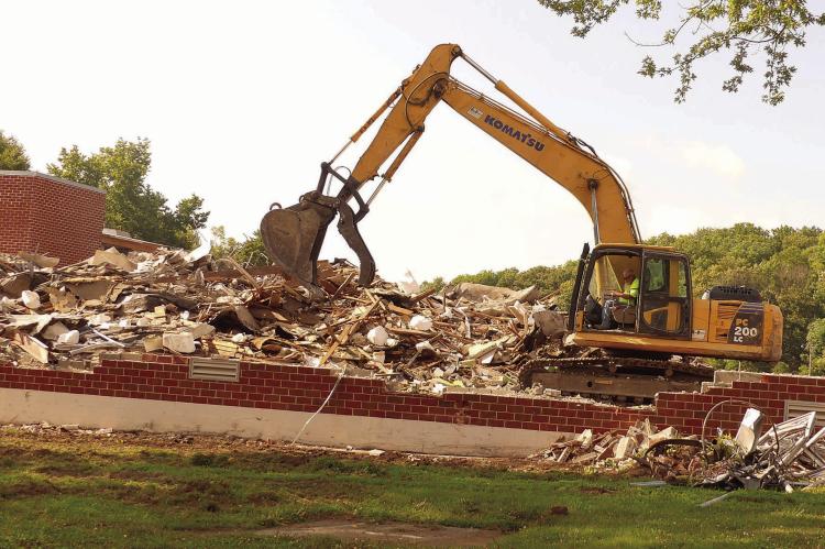 THE EXCAVATORS are knocking down remaining walls on the west side of the school building.