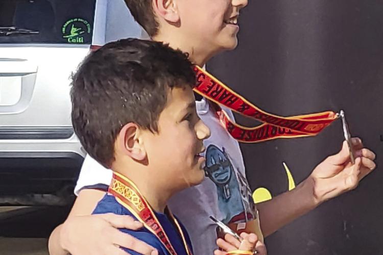 JOSE AND CHRISTIAN GUTIERREZ (top left) pose for a picture with their medals after the race.
