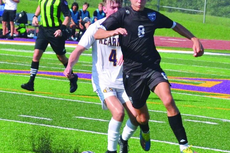 MASON WARTNER, shown here fighting for possession of the ball during a preseason jamboree in August at Kearney, has been among the scorers who’ve helped Excelsior Springs win a third straight district boys soccer title. DUSTIN DANNER | Staff