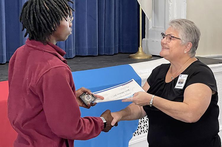 DIRECTOR LORI SAMS presents incoming student Jarvis Stevens his certificate of commitment during the Job Corps Signing Day Sept. 15. BRIAN RICE | Richmond News