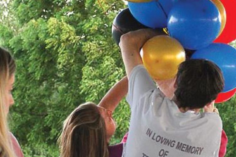 IN MEMORY of Trint Phillips, balloons are arranged around 8:30 p.m. on June 11 undera pavilion roof at Century Park in Excelsior Springs for a launch that takes place at dusk, about 45 minutes later. J.C. VENTIMIGLIA | Staff