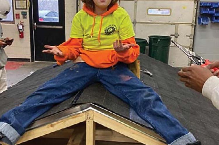 TOGETHER with certifications and a job tip from Excelsior Springs Job Corps, Lauren Randolph, 19, is working on the new terminal roof at KCI. While at Job Corps and at work on this roof model, Randolph says she felt inspired to become a roofer.