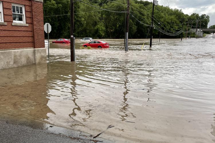 The parking lot behind the Oaks Apartments downtown was flooded, leaving vehicles from some unsuspecting residents stranded. Photo by Brian Rice.