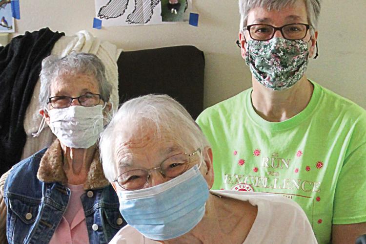 FOR THE FIRST time in a year, family members are able to get together in person with Mary Melvin at Valley Manor Nursing Home. From left are Evelyn Trickel, who is Melvin’s sister; Annette Tracy, Melvin’s daughter; and Melvin.