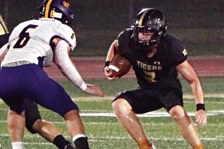 CARSON JACKSON (No. 3) attempts to cut back and find a hole where he can run during Excelsior Springs’ 42-20 season-opening loss to Belton Aug. 25 at Tiger Stadium. TIM HARLAN | Submitted