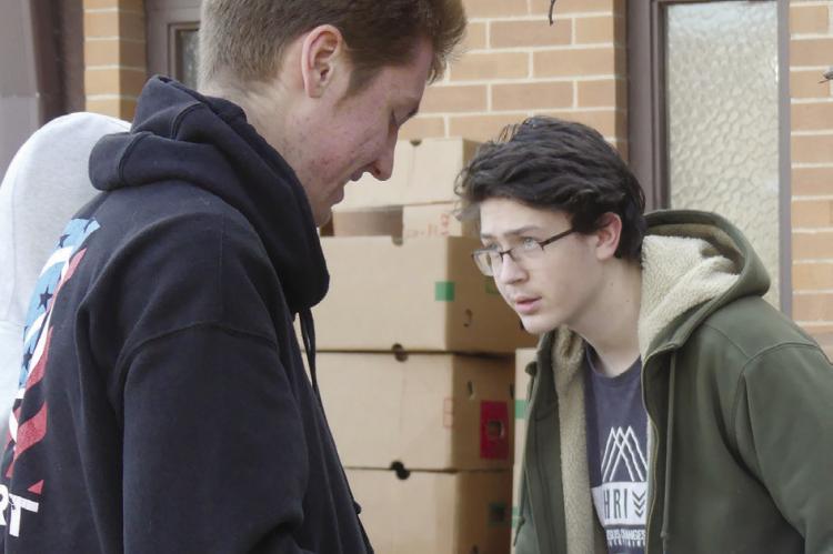 STUDENTS MILTON GRIDER (left) and Mason Henson help others in the community.