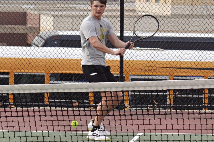 EXCELSIOR SPRINGS SENIOR Colby Mueller prepares to execute a backhand shot during an April 4 home varsity tennis dual with Harrisonville. DUSTIN DANNER | Staff