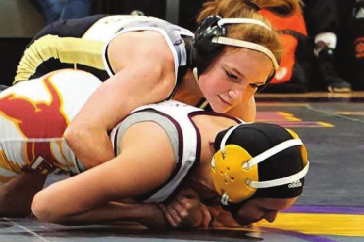 EXCELSIOR SPRINGS freshman grappler Lily Brower gains control over her opponent on her way to claiming a District 4 title. TIM HARLAN