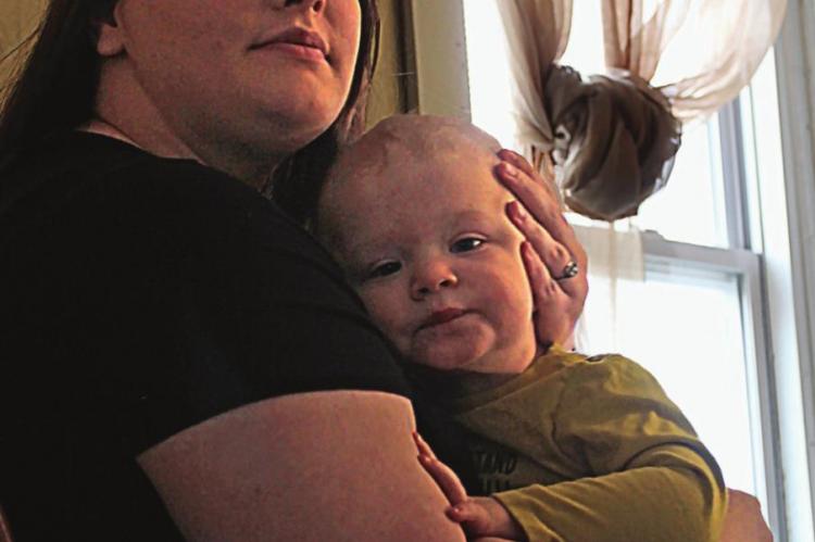 KELSIE REAVIS holds her son, Phoenix, while saying she worries about the lack of health care. J.C. VENTIMIGLIA | Staff