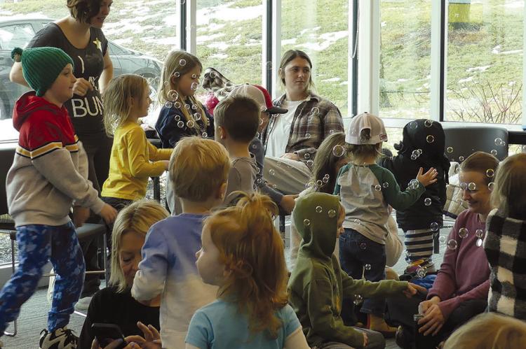 CHILDREN AND THEIR parents gather to play and listen to stories being read by local heroes. ELIZABETH BARNT | Staff