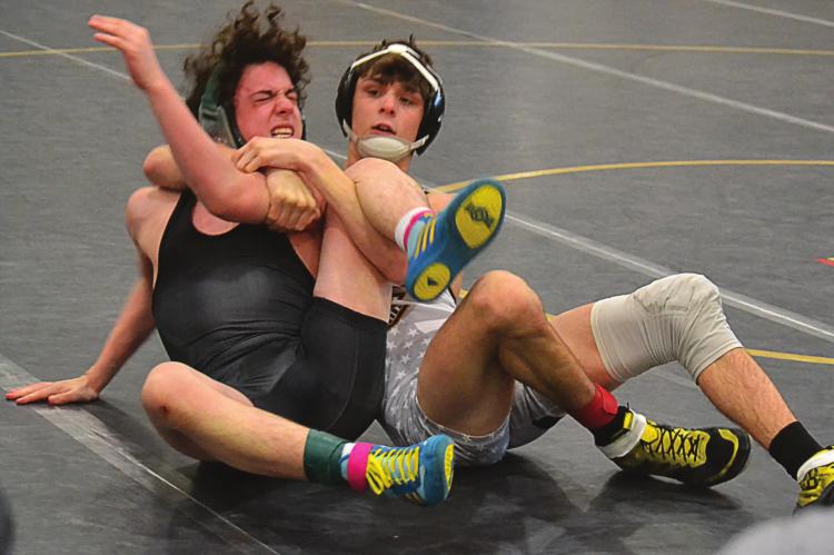FRESHMAN MICAH DANNER secures a cradle in his third-place match at the Class 2 District Tournament Feb. 13 at Excelsior Springs High School. The victory secures Danner’s spot at sectionals. DUSTIN DANNER | Staff