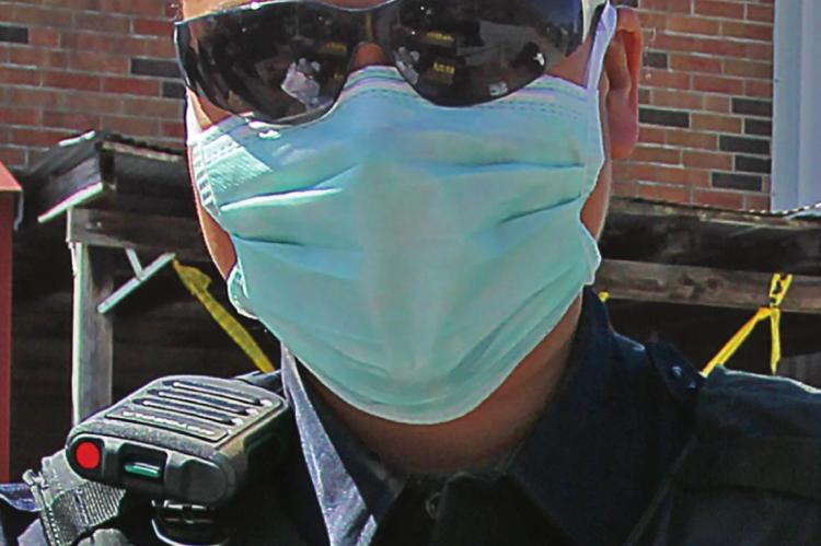 FIRST RESPONDERS RECEIVE FAULTY MASKS RICHMOND Police Officer Chassity Nevels wears a facemask to give out commodities. Masks are expected to help keep wearers from transmitting or being infected by COVID-19, but the state sent emergency management agencies faulty masks. J.C. VENTIMIGLIA | Staff