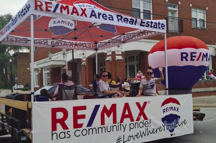 Re/Max Area Real Estate takes first place in the line up of floats. MIRANDA JAMISON | Staff