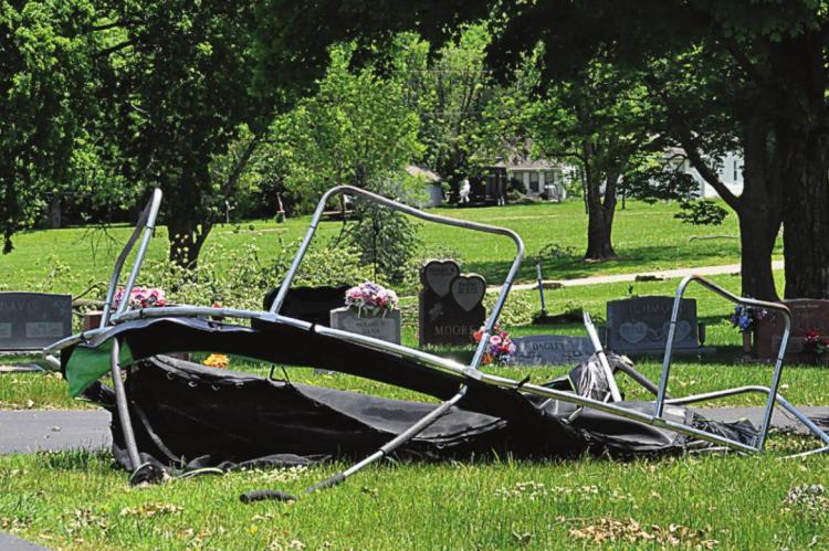 WINDS from the June 11 storm blow a trampoline into Hillcrest Cemetery.