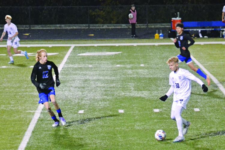 JUNIOR AUSTIN COLLINS (No. 30) controls the possession for Excelsior Springs as Harrisonville defender Seth Estes (No. 12) keeps an eye on the soccer ball during Class 2 state quarterfinal action Nov. 11 at Harrisonville. DUSTIN DANNER | Staff