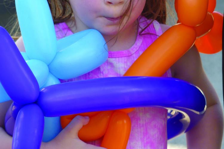 WYNNIE BASIL clings to her balloons as she learns how to make her own balloon costume. See story on page 6. ELIZABETH BARNT | Staff