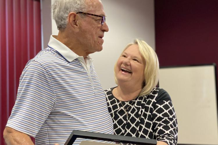 Mayor Sharon Powell offers well wishes to Ambrose Buckman as he steps down from City Council Friday
