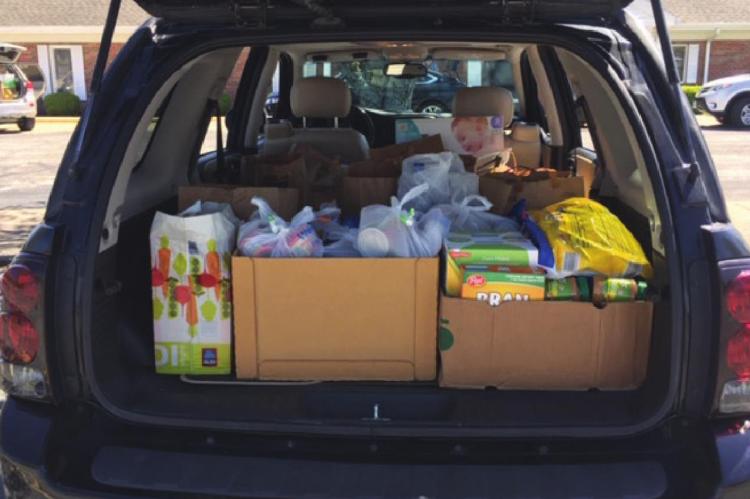 COMMUNITY MEMBERS collect groceries for the Good Samaritan Center.