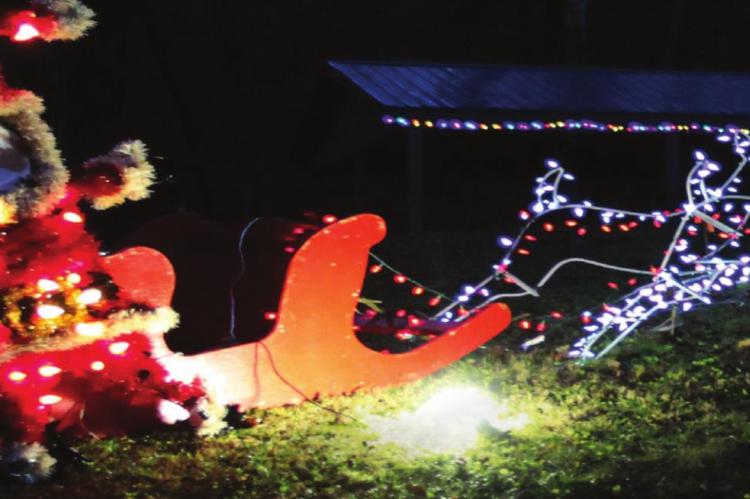 SANTA is visible in a sleigh pulled by reindeer along the Lane of Lights, available nightly through the end of December in Excelsior Springs.