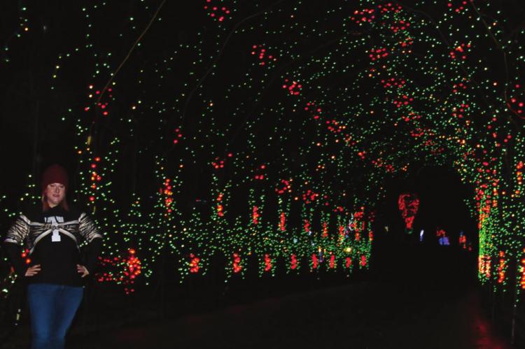 JESSICA MILLER stands within the Kansas City metropolitan area’s longest lighted Christmas tunnel. J.C. VENTIMIGLIA | Staff